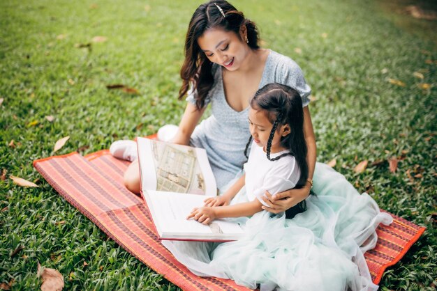 Young woman sitting on book