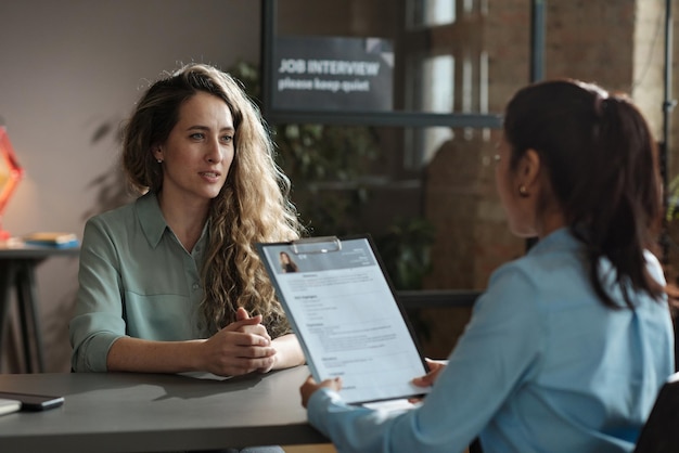 young woman sitting at business interview