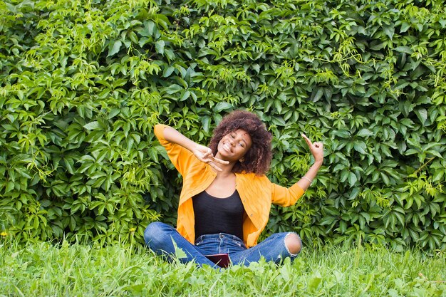 Young woman sitting by plants