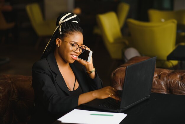 Young woman sitting in a cafe working on a laptop