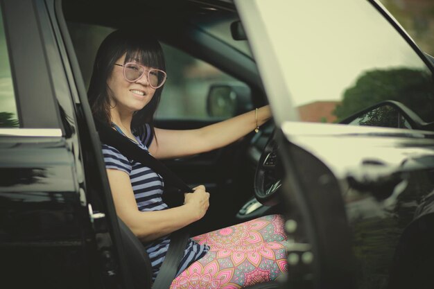 Young woman sitting in car