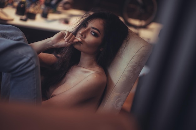 Photo young woman sitting on chair at home