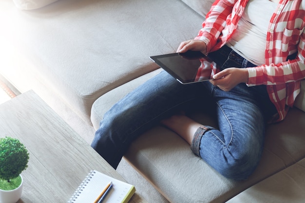 Young woman sitting on the couch