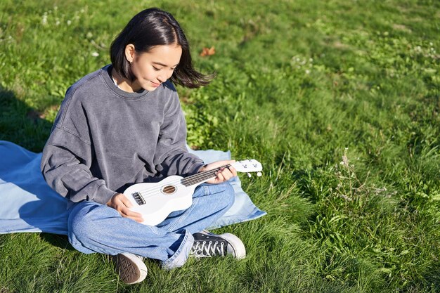 Young woman sitting on field