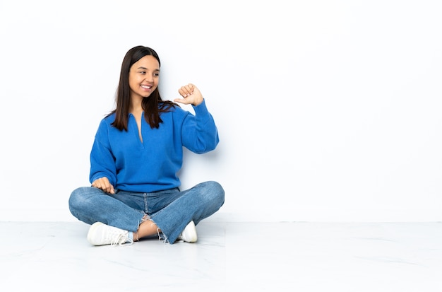 Young woman sitting on the floor