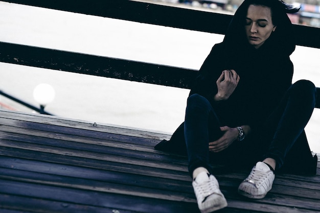 Photo young woman sitting outdoors