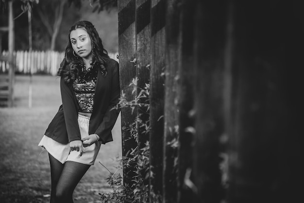 Young woman sitting in a park wearing trendy clothes