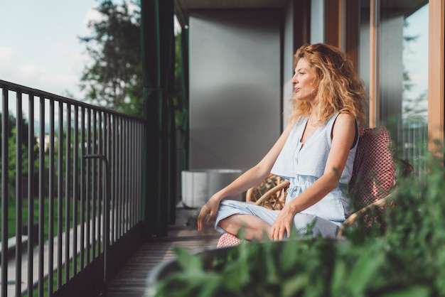 Young woman sitting on railing