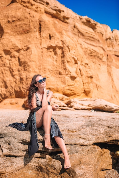 Young woman sitting on rock