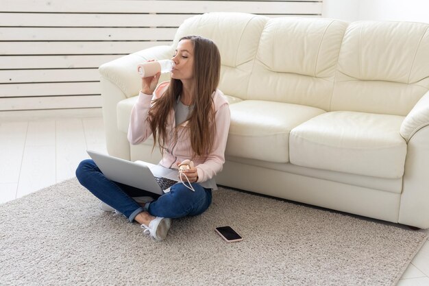 Young woman sitting on sofa at home