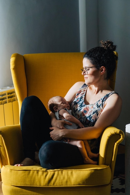 Young woman sitting on sofa at home