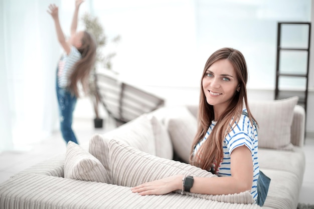 Young woman sitting on sofa in new living room