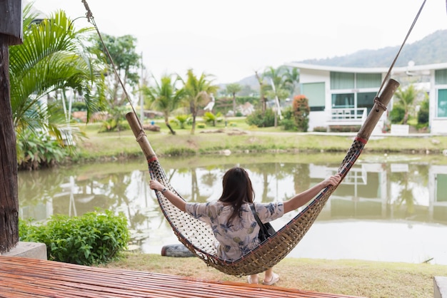 young woman sitting on the swing chair