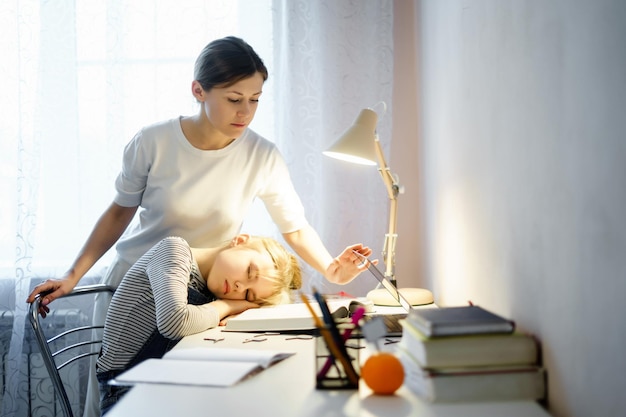 Young woman sitting on table at home