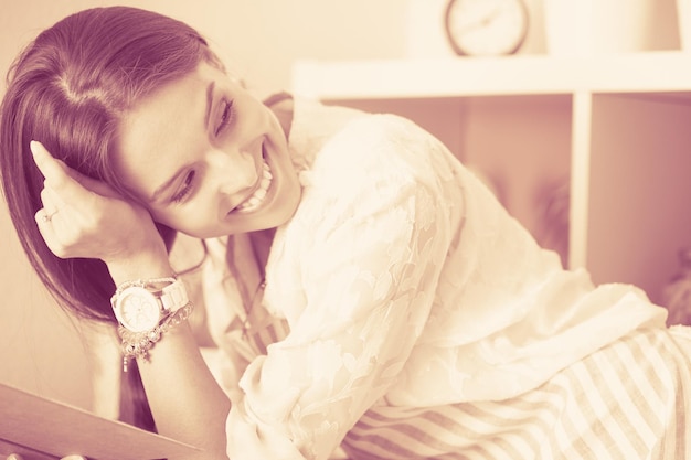 Young woman sitting a table in the kitchen young woman