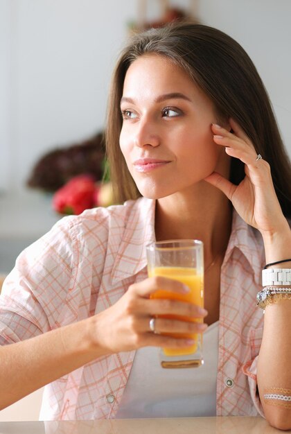 Young woman sitting a table in the kitchen