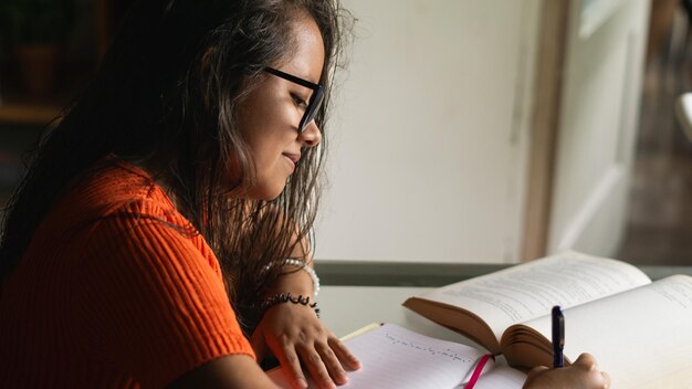 young woman sitting at a table studying