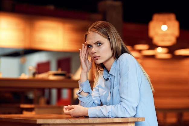 young woman sitting on table