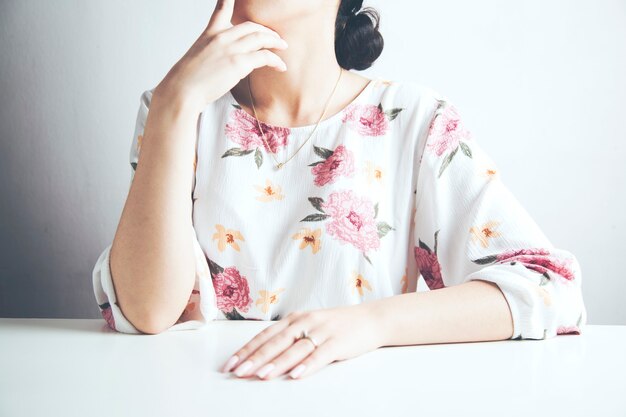 Young woman sitting at table