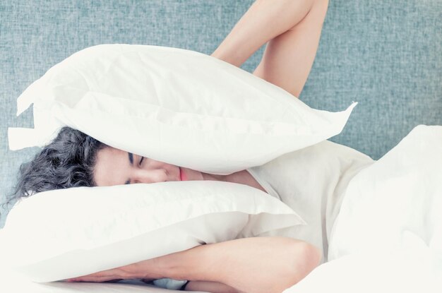 Young woman sleeping on bed at home