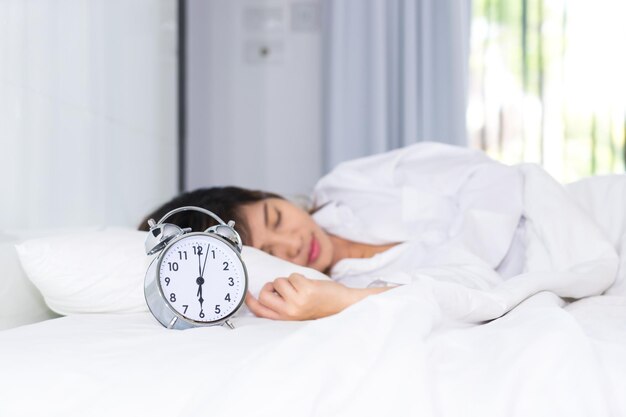 Young woman sleeping on bed at home