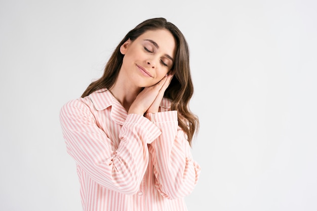 Young woman sleeping in standing position