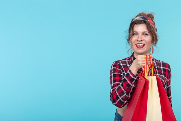 Young woman smiling against blue background