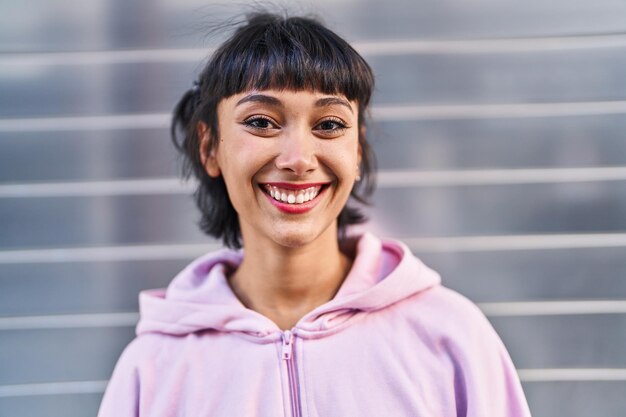 Young woman smiling confident standing at street