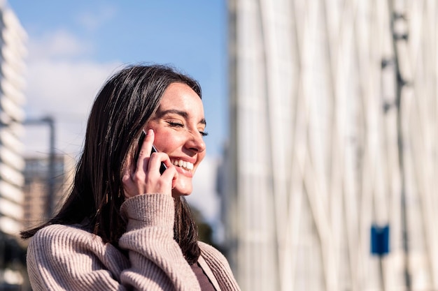 Young woman smiling happy talking on mobile phone