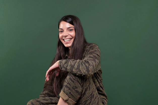 Photo young woman smiling isolated on green