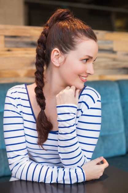 Young woman smiling at table