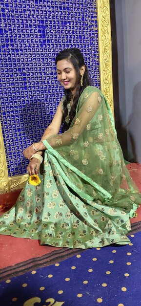 Young woman smiling while sitting against decoration in event