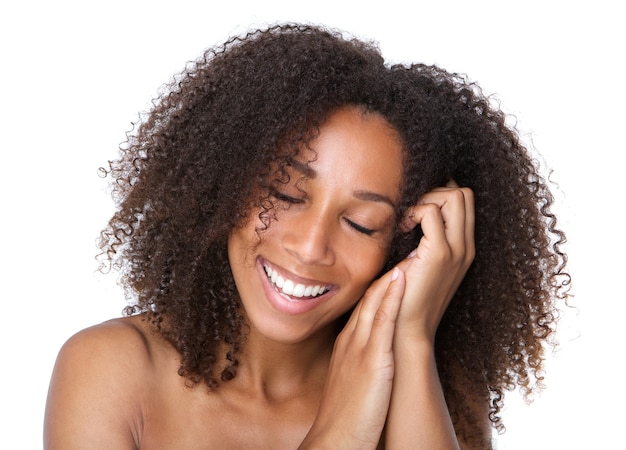 Young woman smiling with eyes closed 