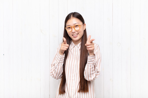 Young woman smiling with a positive, successful, happy attitude