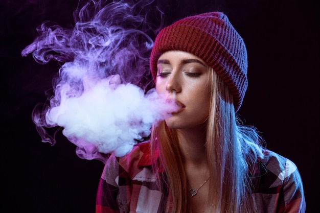 Young woman smoking electronic cigarette