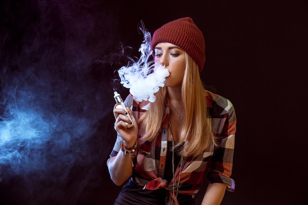 Young woman smoking electronic cigarette