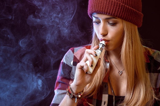 Young woman smoking electronic cigarette