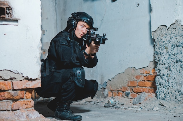 Young woman soldier in black uniform