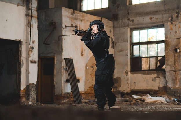 Young woman soldier in black uniform