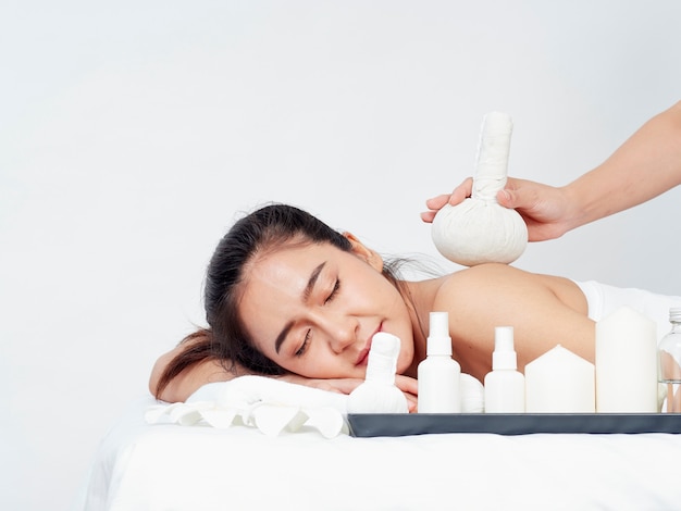 Young woman and spa accessories on massage table