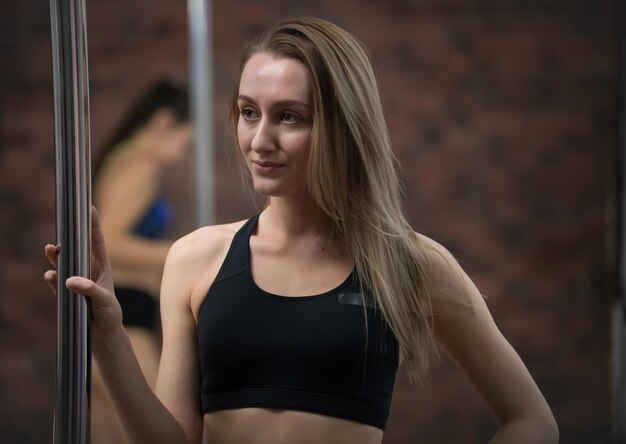 Portrait of beautiful Caucasian female bodybuilder posing with