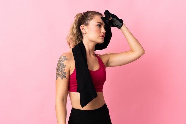 Young woman in sports outfit with a towel