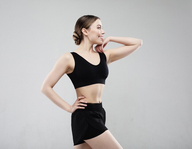Young woman in sportswear posing on a white background sport concept