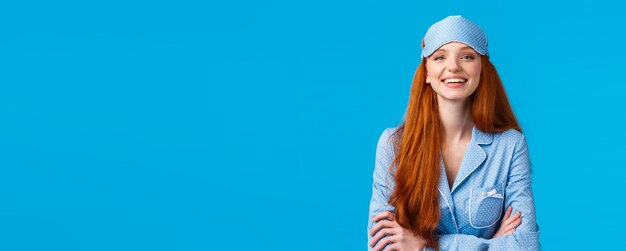 Young woman standing against blue background