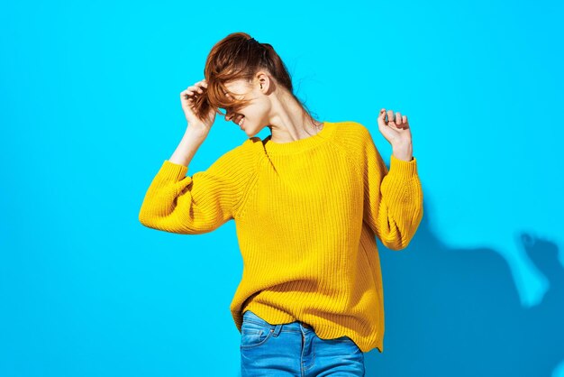 Young woman standing against blue background