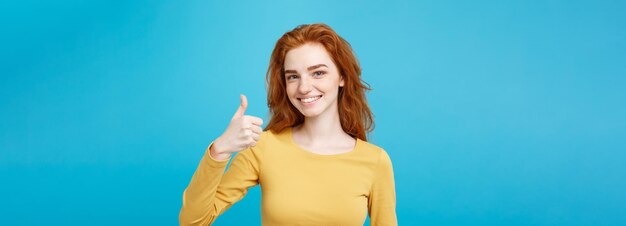 Young woman standing against blue background