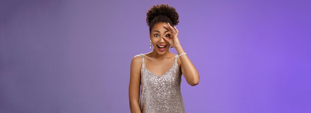 Young woman standing against blue background