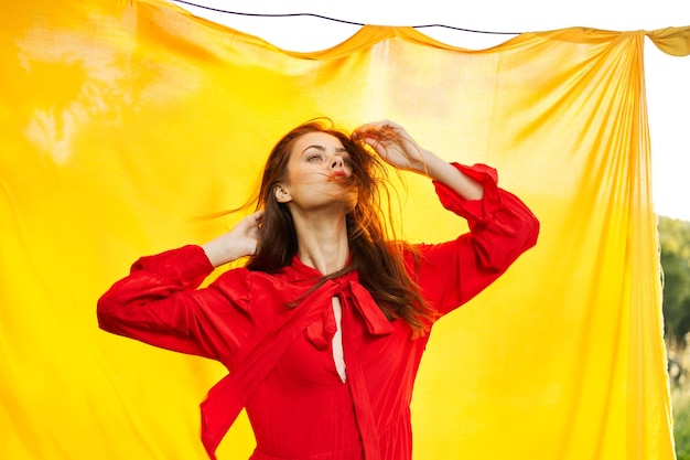 Photo young woman standing against red curtain