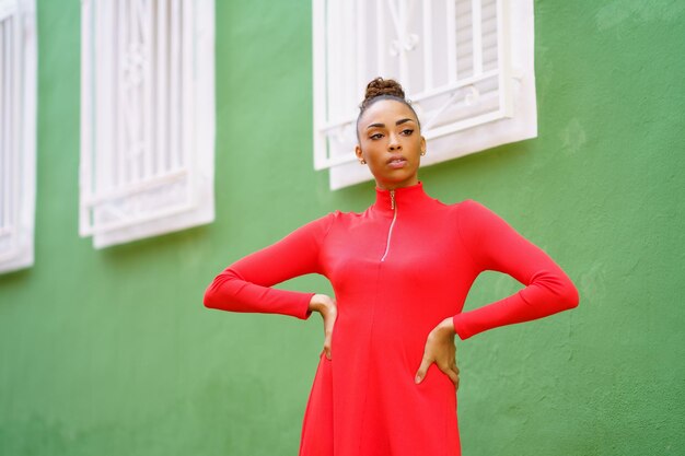 Young woman standing against wall