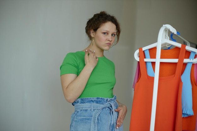 Young woman standing against wall